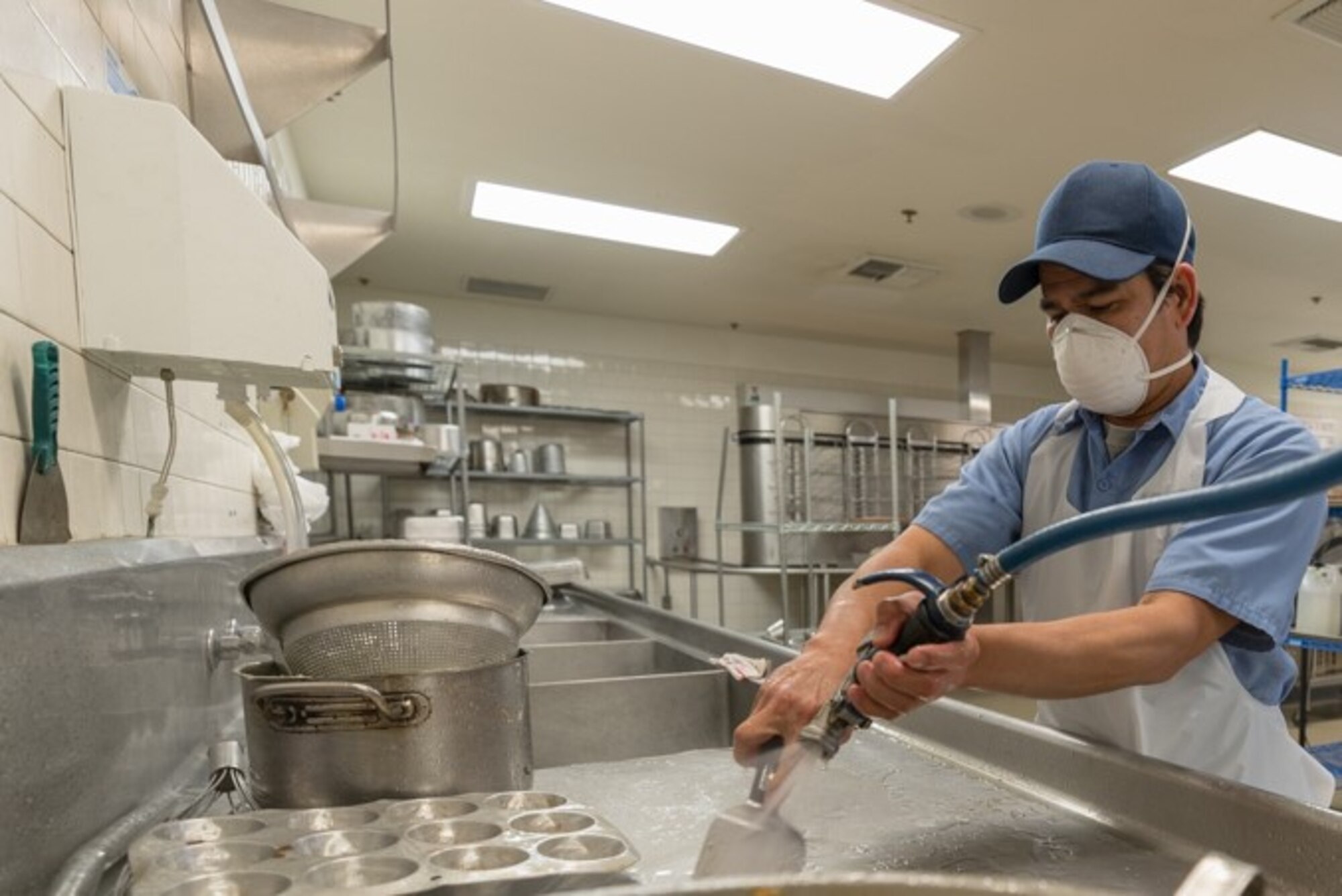 Melvin Pardilla, a prep cook at the base dining facility at Edwards Air Force Base, California, washed dishes between meals, April 7.