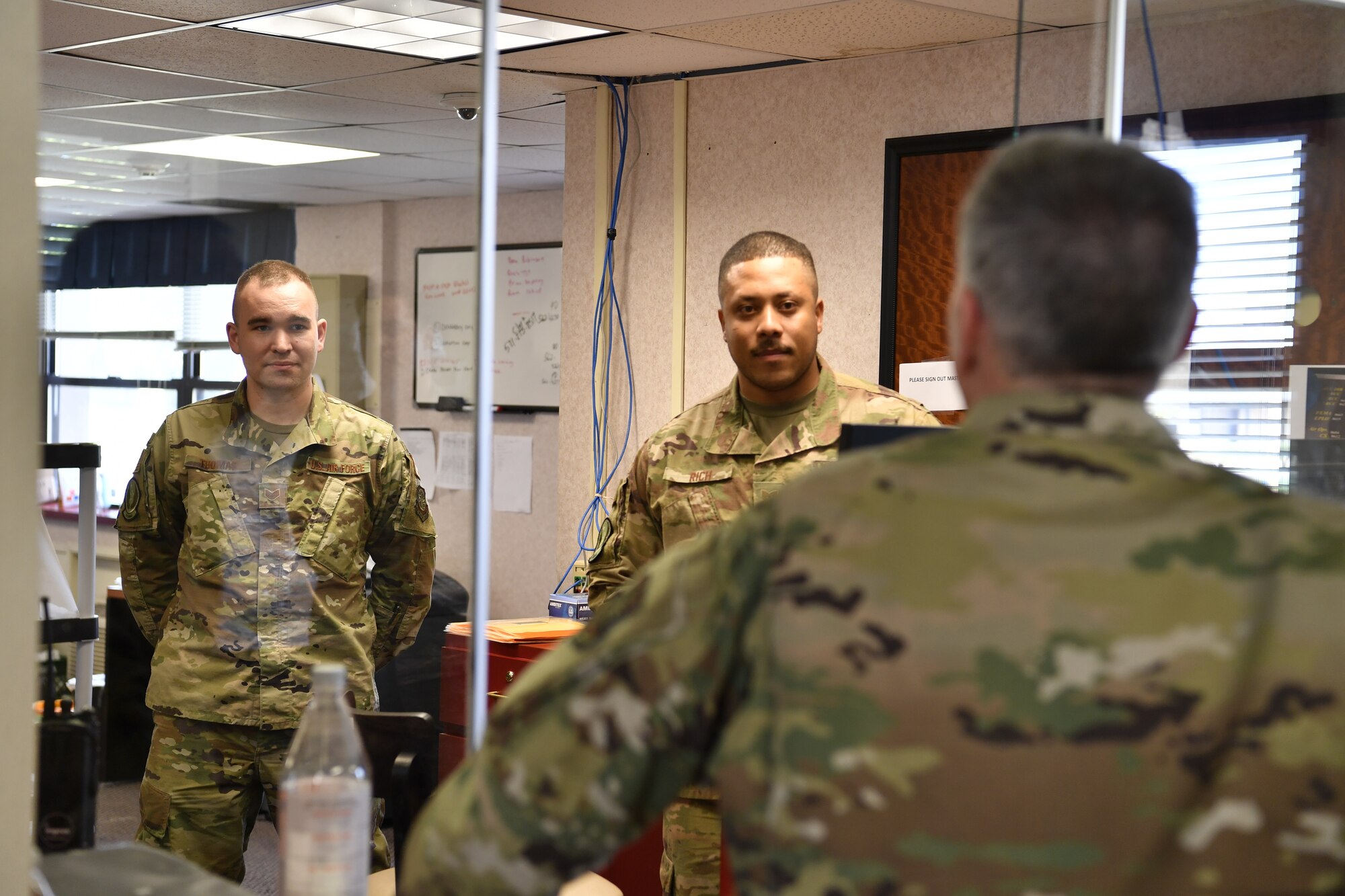 Chaplain (Col.) Michael Husfelt, 87th Air Base Wing senior chaplain, interacts with “Camp JB MDL” front desk personnel on Joint Base McGuire-Dix-Lakehurst, N.J., April 2, 2020. During his visit, Husfelt and his Chapel team went door to door and offered words of encouragement to military members who are quarantined and isolated after newly arriving onto the installation.