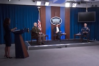 Defense Secretary Dr. Mark T. Esper, Chairman of the Joint Chiefs of Staff Army Gen. Mark A. Milley and Senior Enlisted Advisor to the Chairman Ramón “CZ” Colón-López sit on a stage.
