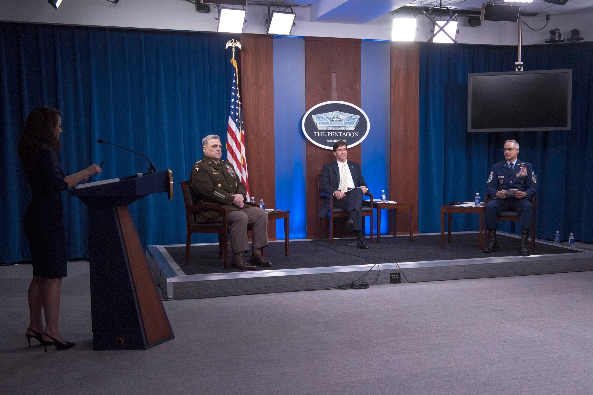 Defense Secretary Dr. Mark T. Esper, Chairman of the Joint Chiefs of Staff Army Gen. Mark A. Milley and Senior Enlisted Advisor to the Chairman Ramón “CZ” Colón-López sit on a stage.