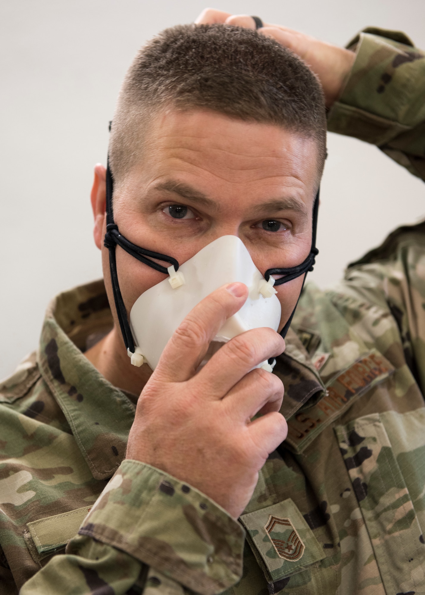 An Airman puts on a mask.