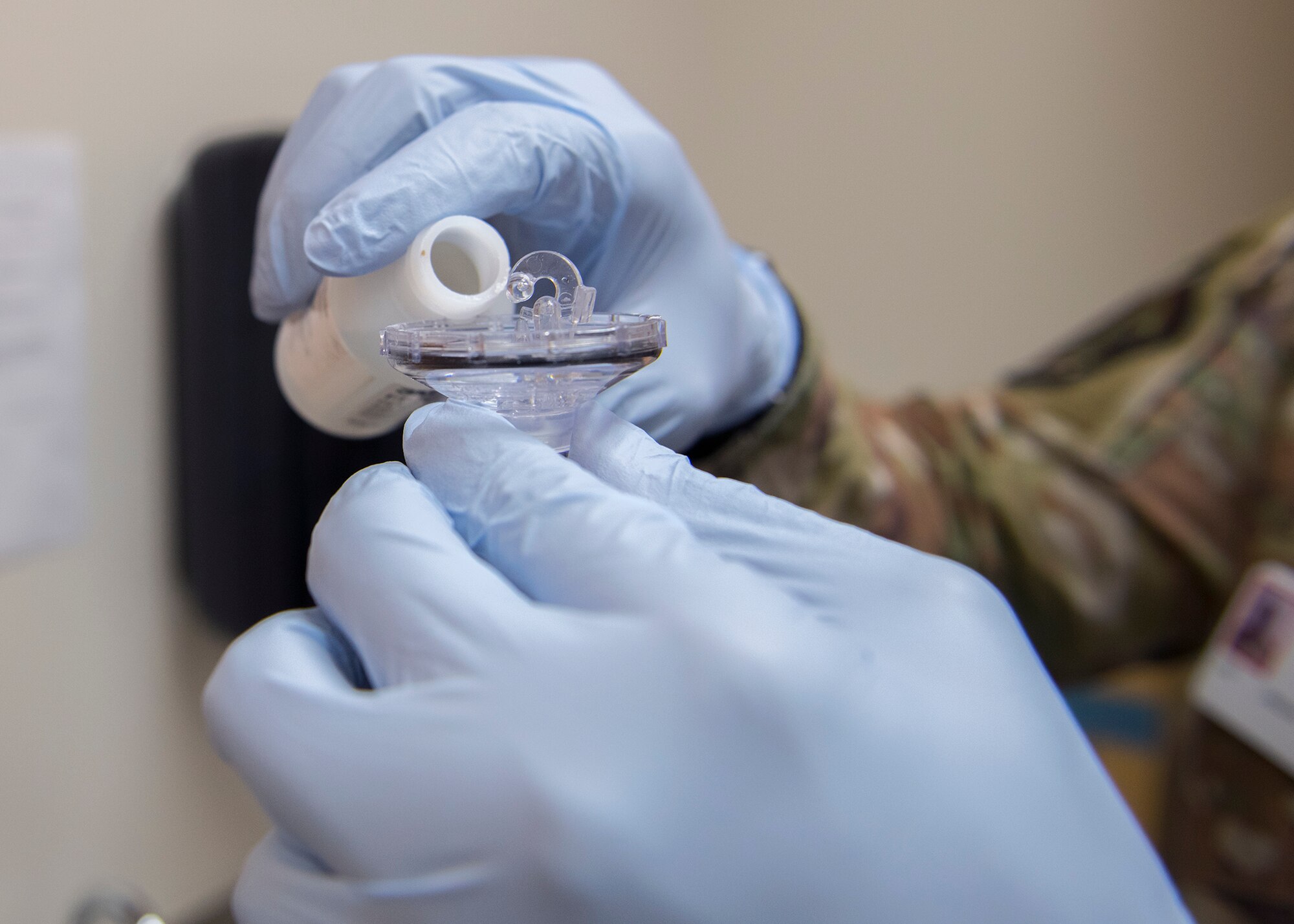 Senior Airman Gregory Rackley, 56th Bioenvironmental Engineer technician, pours sensitivity solution into a nebulizer before a protective mask fitting test April 1, 2020, at Luke Air Force Base, Ariz.