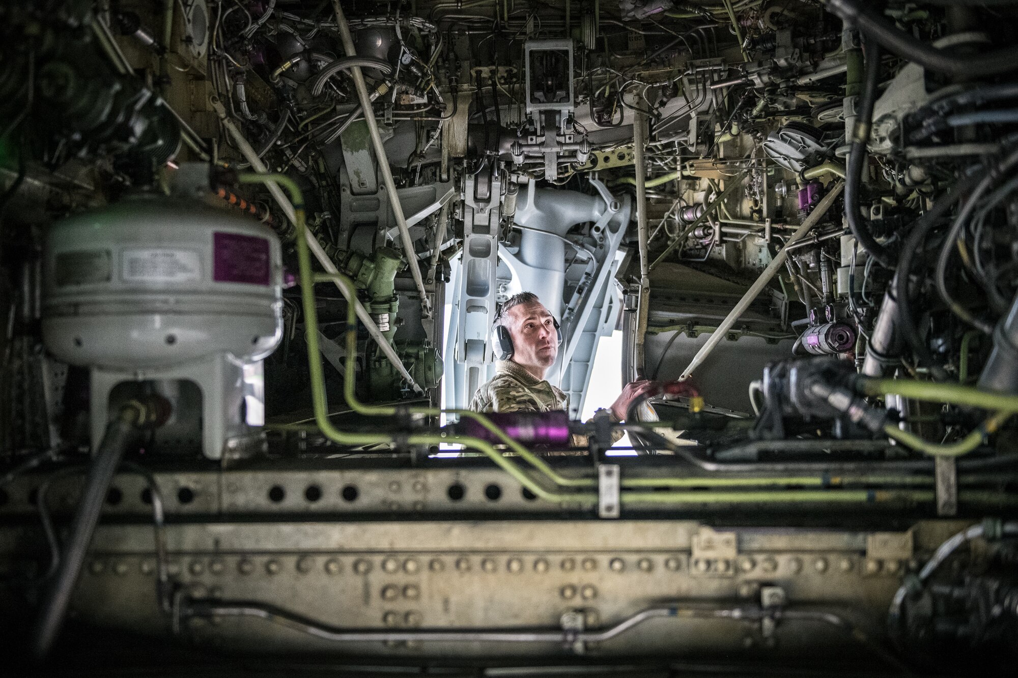 Senior Master Sgt. Brandon Whittom, crew chief, 932nd Maintenance Squadron, performs a physical preflight inspection March, 20, 2020 Scott Air Force Base Illinois as the 932nd Airlift Wing and 73rd Airlift Squadron continue training operations during COVID-19.  Pilots are required to maintain readiness and the 932nd MXS is working hard with reduced manning in support of continued missions. The 932nd Airlift Wing is the only Air Force Reserve Command unit that flies the C-40C, which is used to provide world-class airlift for U.S. national and military leaders.(U.S. Air Force photo by Christopher Parr)