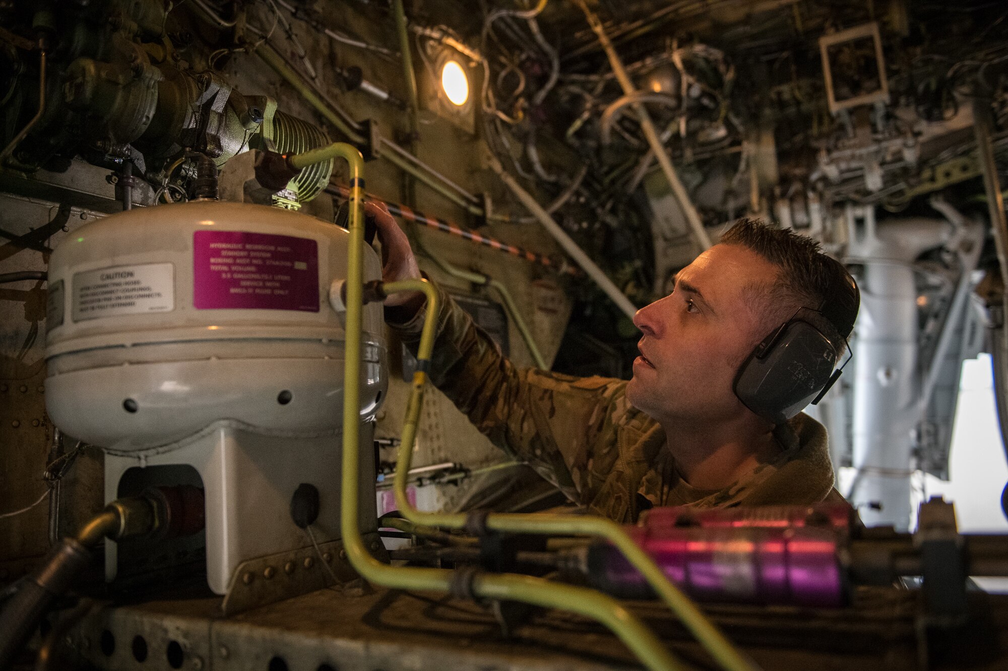 Senior Master Sgt. Brandon Whittom, crew chief, 932nd Maintenance Squadron, performs a physical preflight inspection March, 20, 2020 Scott Air Force Base Illinois as the 932nd Airlift Wing and 73rd Airlift Squadron continue training operations during COVID-19.  Pilots are required to maintain readiness and the 932nd MXS is working hard with reduced manning in support of continued missions. The 932nd Airlift Wing is the only Air Force Reserve Command unit that flies the C-40C, which is used to provide world-class airlift for U.S. national and military leaders.(U.S. Air Force photo by Christopher Parr)