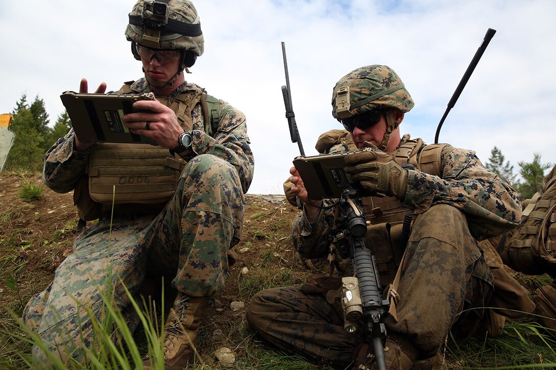 U.S. Marines with Marine Rotational Force-Europe 18.1 relay information through the Marine Air Ground Task Force Common Handheld during a platoon-supported attack range at Giskas, Norway, Aug. 7, 2018. In December 2019, Marine Corps Systems Command fielded the upgraded version of MCH that increases interoperability and reduces bandwidth. (U.S. Marine Corps photo by Cpl. Gloria Lepko/Released)