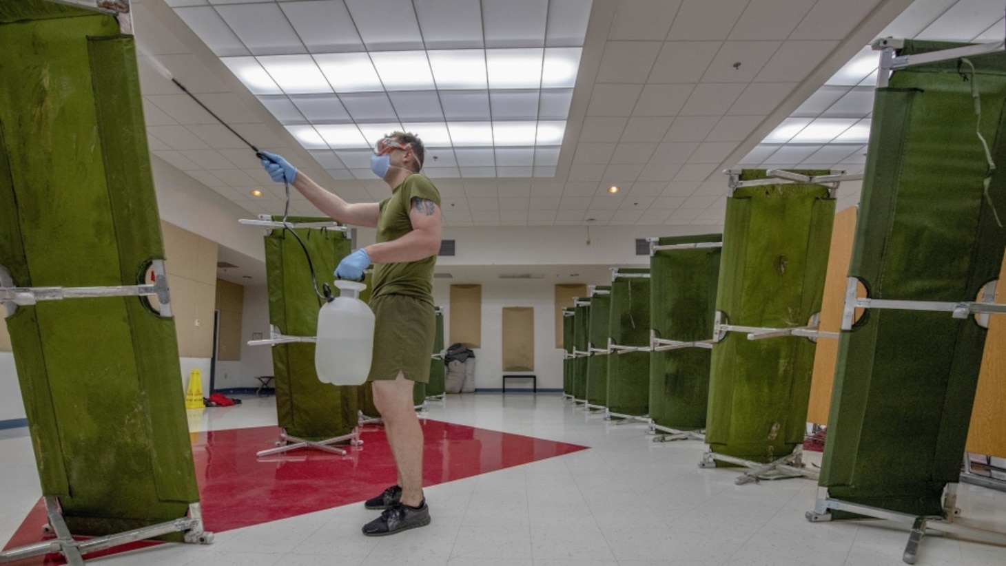 NAVAL BASE GUAM (April 9, 2020) Hospital Corpsman 3rd Class Tyler Seibert assigned to 3rd Medical Battalion, 3rd Marine Logistics Group, sterilize a building in support of USS Theodore Roosevelt (CVN 71) Sailors. Theodore Roosevelt is docked at Naval Base Guam where Sailors from the ship are practicing social distancing and following other guidelines from the CDC, U.S. Navy and the Governor of Guam as part of a COVID-19 mitigation effort during a scheduled deployment to the Indo-Pacific.