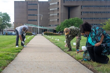 Norfolk Naval Shipyard’s (NNSY) and Suffolk Complex’s Sexual Assault Response Coordinator (SARC) Shalise Bates-Pratt and select individuals continued to observe the yearly tradition of placing small flags along the walkway in front of NNSY’s Norman Sisisky Management and Engineering Building, each flag with handwritten message to victims of sexual assault showing support.