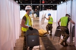 Members of the Illinois Air National Guard assemble an alternate care facility at the McCormick Place Convention Center in Chicago April 8, 2020. Sixty Guard members were activated to support the US Army Corps of Engineers and the Federal Emergency Management Agency to set up the facility for COVID-19 patients with mild symptoms who do not require intensive care.