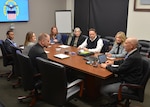 Air Force and Aviation employees talk around conference table