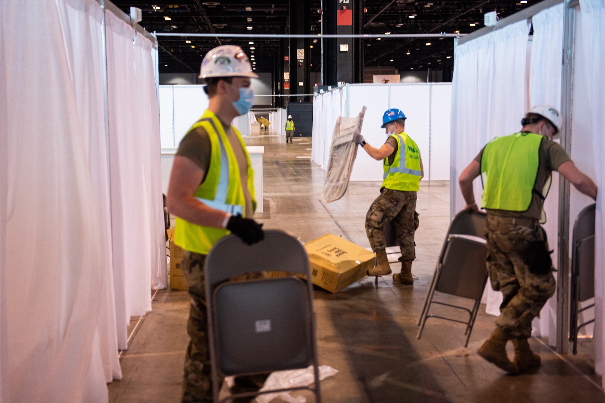 Members of the Illinois Air National Guard assemble an alternate care facility at the McCormick Place Convention Center in Chicago April 8, 2020. Sixty Guard members were activated to support the US Army Corps of Engineers and the Federal Emergency Management Agency to set up the facility for COVID-19 patients with mild symptoms who do not require intensive care.
