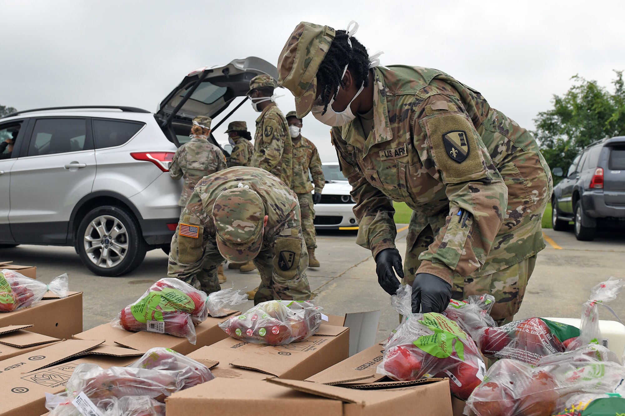 Members of the Louisiana National Guard, 205th Engineer Battalion, help distribute food for the Great Baton Rouge Food Bank in Walker, Louisiana, April 9, 2020. Guard members have helped package and distribute over 580,540 pounds of food while assisting five food banks throughout the state.