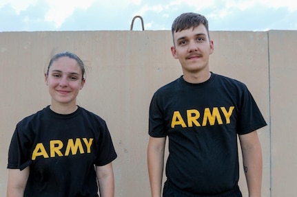 U.S. Army Spc. Jacqueline Herzog stands next to her brother, Pfc. Jeremiah  Herzog, in the Middle East while supporting Operation Spartan Shield, April 9, 2020.  The North Carolina National Guard Soldiers were reunited after eight months of separation, just in time for Siblings Day,  which is recognized on April 10.