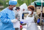 Louisiana National Guard Soldiers and Airmen collect nasal swabs from patients during a drive-through, community-based COVID-19 testing site in New Orleans March 20, 2020. More than 28,000 National Guard members have been mobilized throughout the country as part of COVID-19 response efforts, with additional Soldiers and Airmen expected to come on duty in the coming weeks.