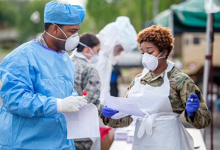 Louisiana National Guard Soldiers and Airmen collect nasal swabs from patients during a drive-through, community-based COVID-19 testing site in New Orleans March 20, 2020. More than 28,000 National Guard members have been mobilized throughout the country as part of COVID-19 response efforts, with additional Soldiers and Airmen expected to come on duty in the coming weeks.