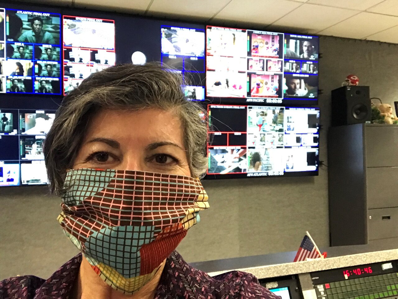 A woman models a large, multicolored facemask.