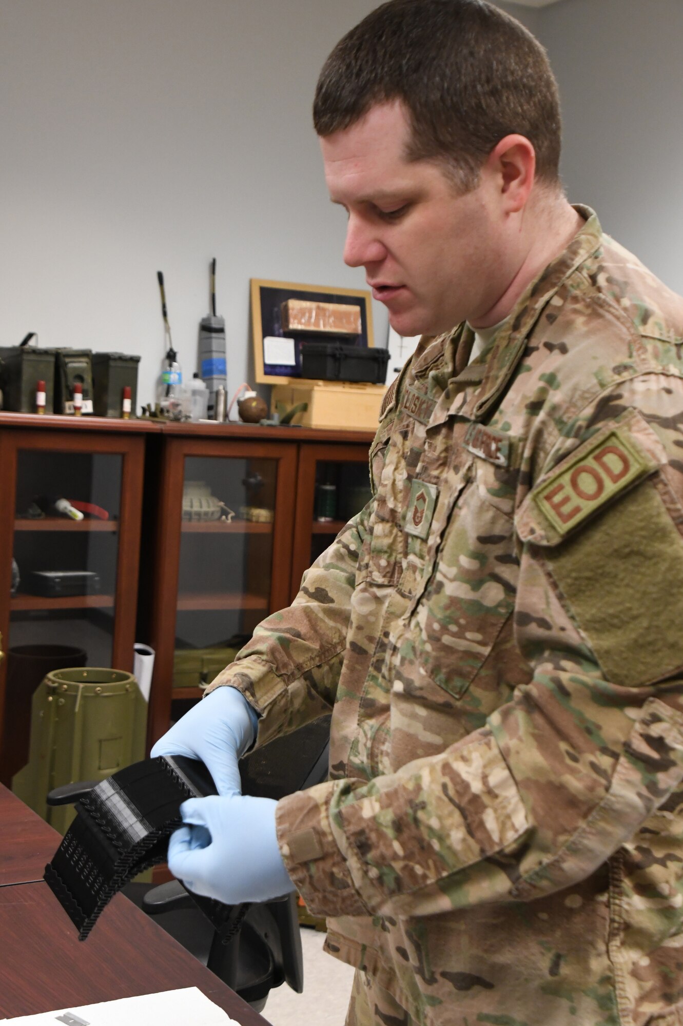 Senior Master Sgt. Jeremiah Mcclosky, Explosive Ordnance Disposal Superintendent, 104th Fighter Wing, prints a protective mask from a 3D printer for the 104th Fighter Wing Medical Group. The 104th Fighter Wing Medical Group is responding to state COVID-19 response efforts throughout the state of Massachusetts. (U.S. Air National Guard photo by Airman 1st Class Sara Kolinski)