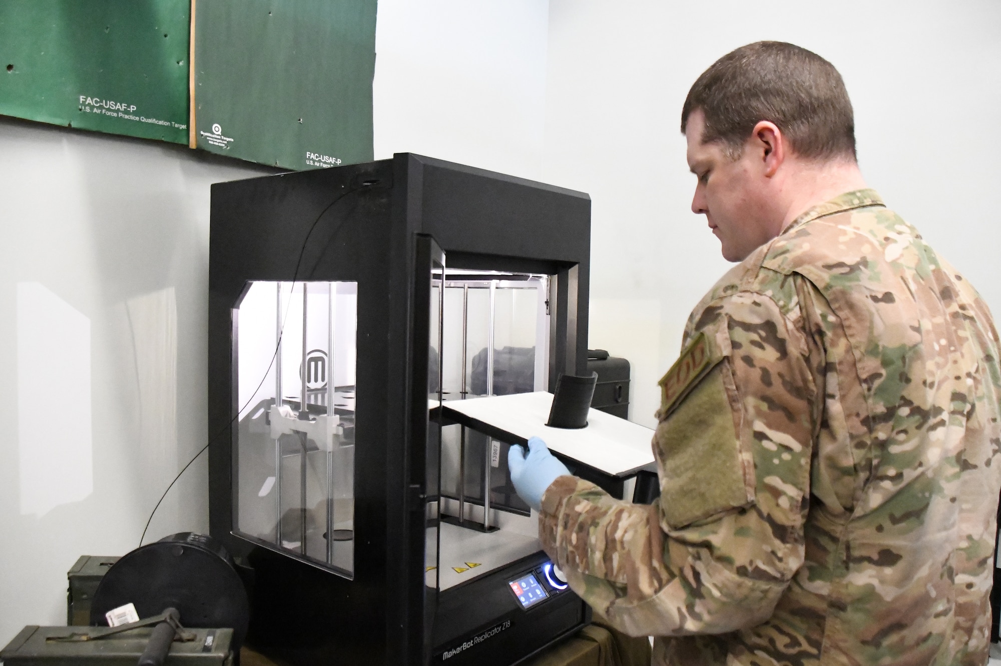 Senior Master Sgt. Jeremiah Mcclosky, Explosive Ordnance Disposal Superintendent, 104th Fighter Wing, prints a protective mask from a 3D printer for the 104th Fighter Wing Medical Group. The 104th Fighter Wing Medical Group is responding to state COVID-19 response efforts throughout the state of Massachusetts. (U.S. Air National Guard photo by Airman 1st Class Sara Kolinski)