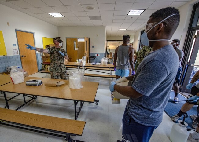 NAVAL BASE GUAM (April 9, 2020) Sailors and Marines from 3rd Medical Battalion, 3rd Marine Logistics Group, sterilize a building in support of USS Theodore Roosevelt (CVN 71) Sailors. Theodore Roosevelt is docked at Naval Base Guam where Sailors from the ship are practicing social distancing and following other guidelines from the CDC, U.S. Navy and the Governor of Guam as part of a COVID-19 mitigation effort during a scheduled deployment to the Indo-Pacific.