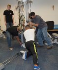 MCLB Barstow Marine volunteers team up to readjust the placement of a universal gym, although in pieces, to make sure it is placed in its proper spot in the Veterans Home of California work out room.