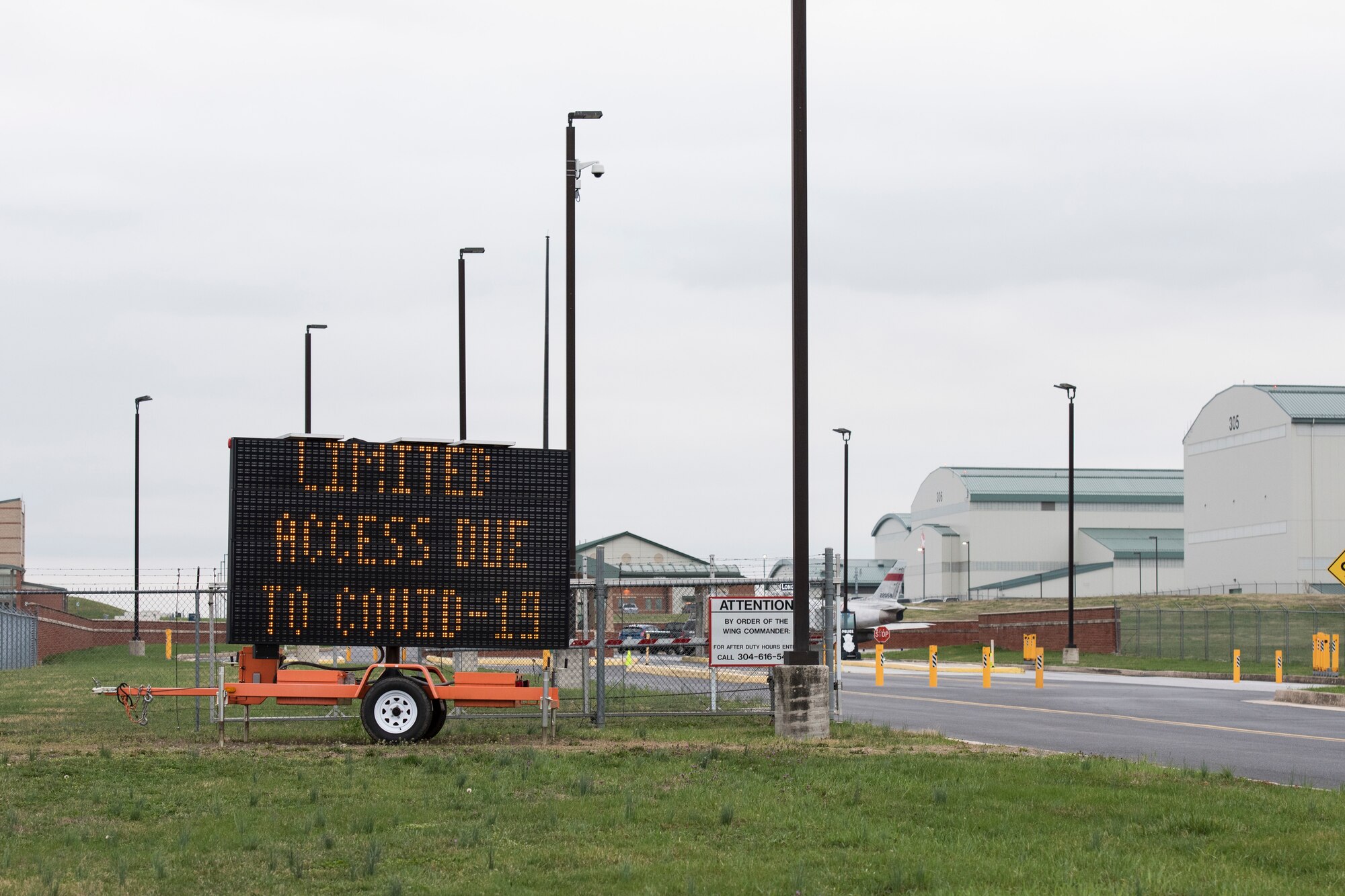 A sign at the main gate of the 167th Airlift Wing warns drivers of limited access to the installation. The wing began transitioning Airmen to telework in mid-March and within a week only mission essential personnel were working on the base. Everyone entering the basewas medically screened before proceeding through the gate.