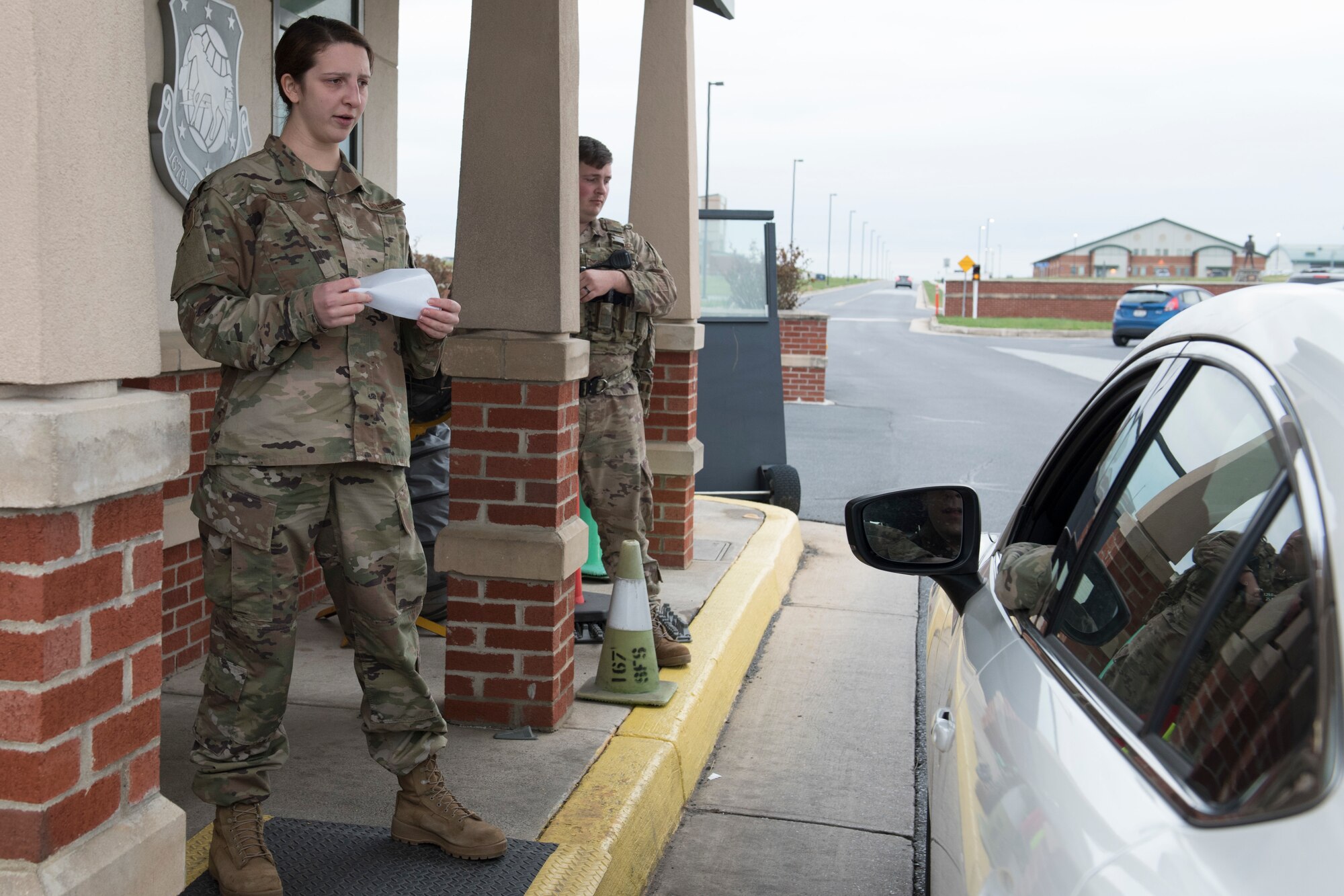Airman 1st Class Whitney Potts, conducts a medical screening at the main gate of the 167th Airlift Wing March 24, 2020, to prevent the spread of COVID-19. Those entering the base were asked a series of questions to determine if they could have potentially been contaminated. Several days later the base implemented temperature checks at the gate as well.