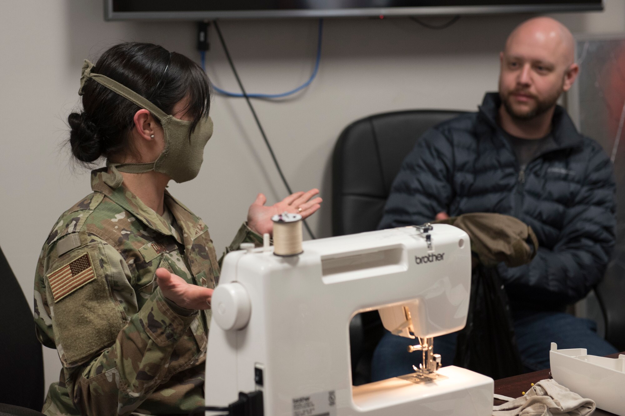 Chief Master Sgt. Tracie Darby, 167th Medical Group superintendent, demonstrates how to make cloth face masks from t-shirts to 167th personnel, April 7, 2020. The face mask contained three layers of fabric and included a pocket to hold a filter of the wearer’s choice. The Department of Defense issued guidance April 5, calling for all individuals on military installations to wear cloth face coverings when six feet of physical distance cannot be maintained in work centers and public spaces.