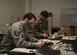 Tech Sgt. Jamey Paddock (left), 459th Operations Support Squadron, Aircrew Flight Equipment technician, and Senior Master Sgt. Megan Kuszewski (right) 459th OSS, AFE superintendent, work together to make Air Force authorized face masks, April 10th, 2020, at Joint Base Andrews, Md. The team plans to make at least 1,000 face masks to distribute to aircrew members, maintainers and members of the wing as they continue to work through COVID-19. (U.S. Air Force photo/Staff Sgt. Cierra Presentado)