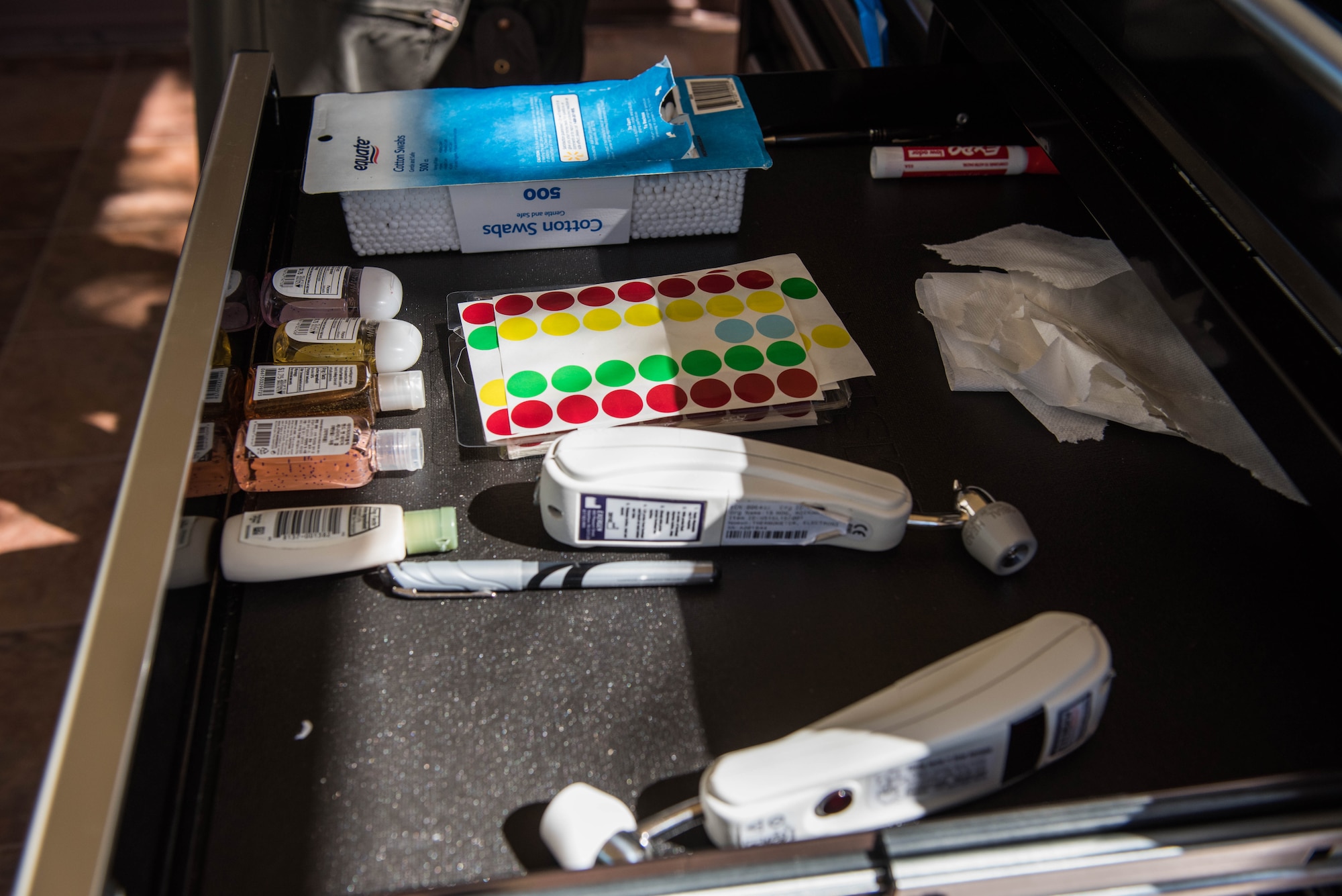 Supplies sit in a drawer outside the 613th Air Operations Center on Joint Base Pearl Harbor-Hickam, Hawaii, April 1, 2020. Members assigned to the AOC take new precautionary measures to maintain the health and safety of mission essential personnel. These measures include: health screening questions, temperature checks and hand sanitizing. (U.S. Air Force photo by Staff Sgt. Hailey Haux)