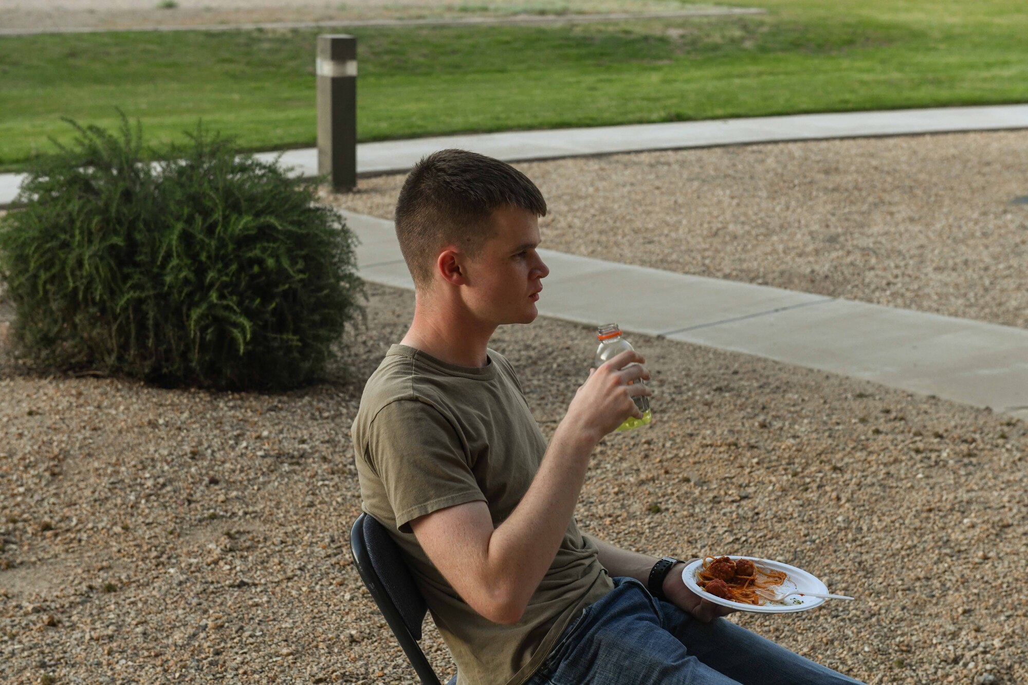 Airman 1st Class Jack Hodnett, 56th Medical Support Squadron resource management technician, practices social distancing while attending the Oasis dinner, April 3, 2020, at Luke Air Force Base, Ariz. The Oasis hosted the event outside to continue serving the Airmen free meals, while adhering to preventative health measures. The Oasis is a chapel-sponsored helping organization for dorm Airmen that provides a safe and open environment for Airmen to connect and bond through various activities to include providing home-cooked meals. (U.S. Air Force photo by Airman Tyler Jansen)