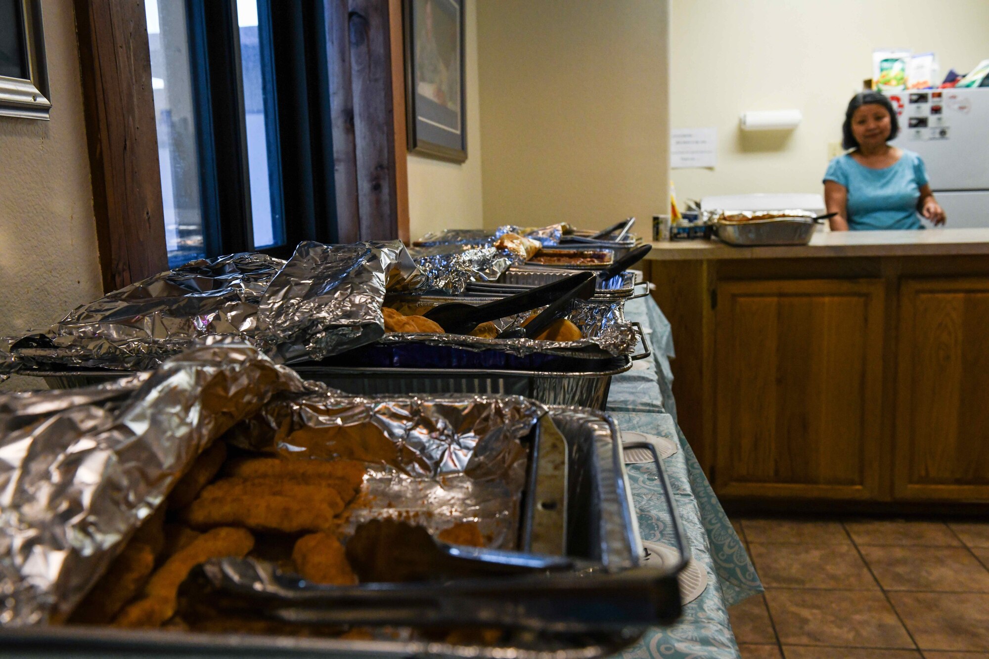 Ms. Loida Legang, Main Luke Community Chapel catholic religious education director, cleans dishes after preparing food for the Oasis dinner, April 3, 2020, at Luke Air Force Base, Ariz. The dinner is hosted every Friday and Saturday and is open to all Luke AFB Airmen. The Oasis is a chapel-sponsored helping organization for dorm Airmen that provides a safe and open environment for Airmen to connect and bond through various activities to include providing home-cooked meals. (U.S. Air Force photo by Airman Tyler Jansen)
