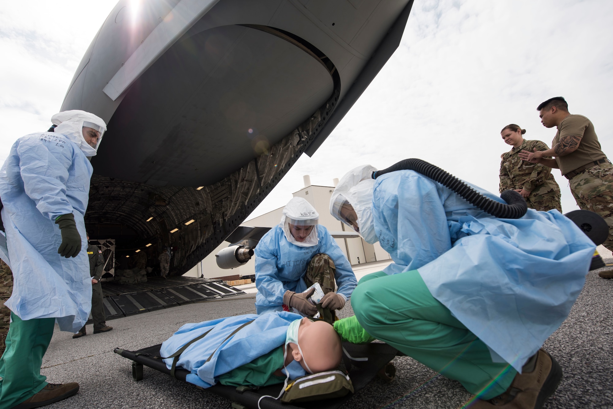 Airmen participating in Transport Isolation System training prepare a mock patient for transport during a training scenario at Joint Base Charleston, S.C., April 5, 2020.