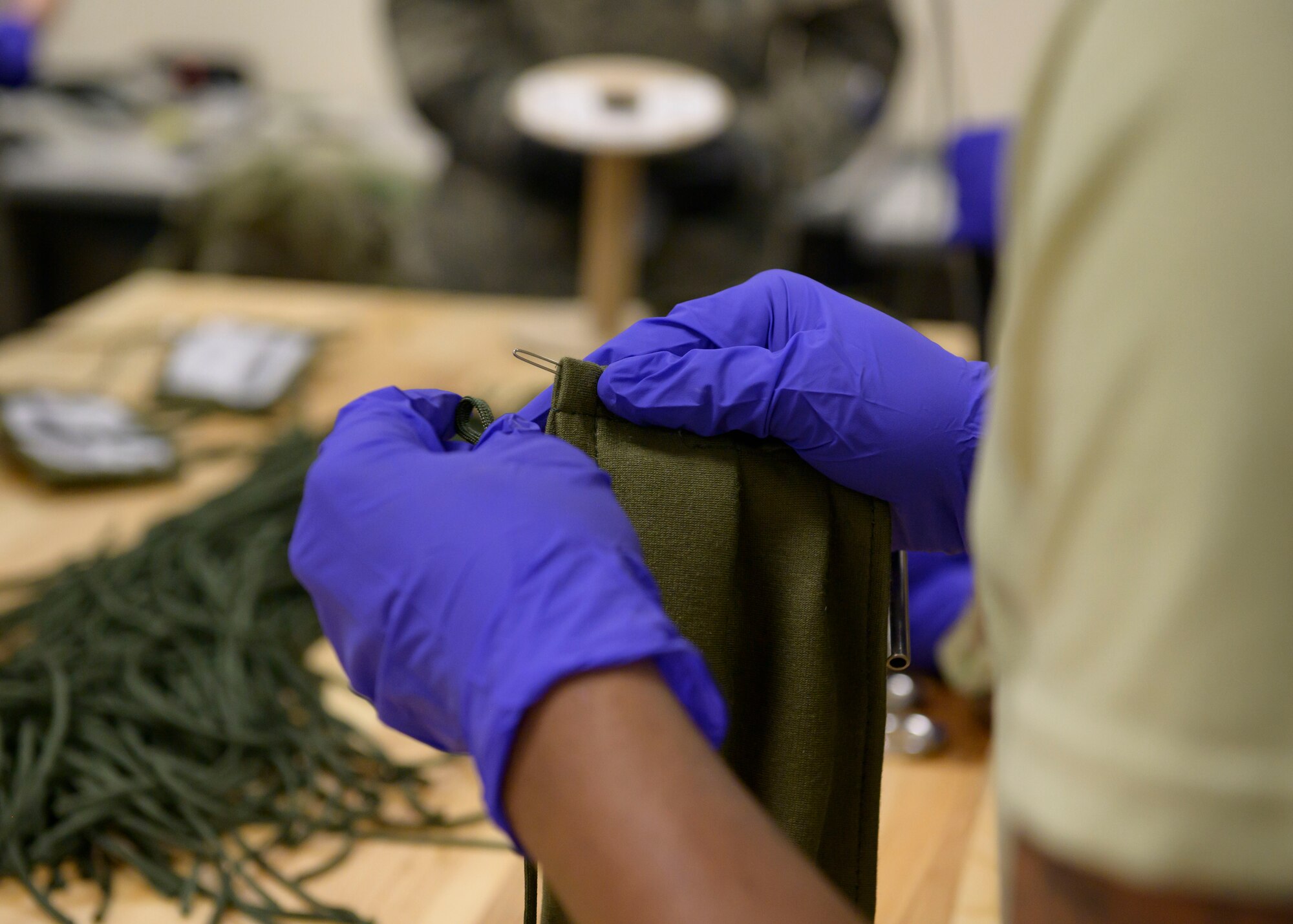 Airmen from the 366th Operations Support Squadron, craft masks for personnel on base, March 20, 2020, at Mountain Home Air Force Base, Idaho. These masks are designed in a multi-layer style to further deter the spread of CVOID-19. (U.S. Air Force photo by Senior Airman Tyrell Hall)