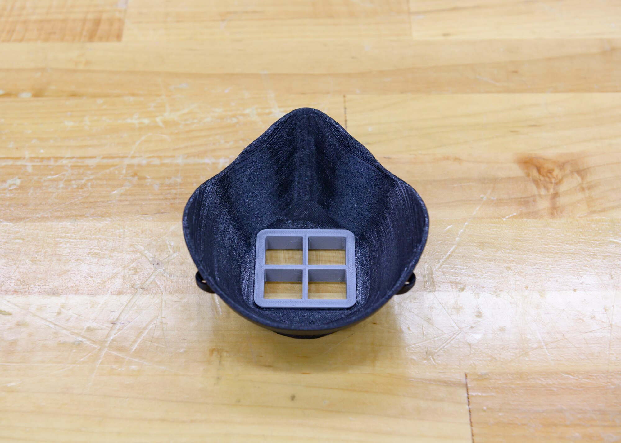 A face mask designed by the 366th Munitions Squadron is showcased on a work table, March 8, 2020, at Mountain Home Air Force Base, Idaho. The masks were made for mission essential personnel to protect them while they continue to perform their duties amid the COVID-19 pandemic. (U.S. Air Force photo by Senior Airman Tyrell Hall)