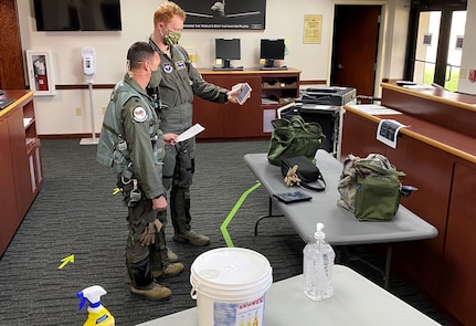 Second Lt. Frank Toohey and 559th Flying Training Squadron instructor pilot Lt. Col. Dan Healey recieve a brief from operations superintendent Lt. Col. John Urso and Jeff Madison of the 12th Operations Support Squadron.