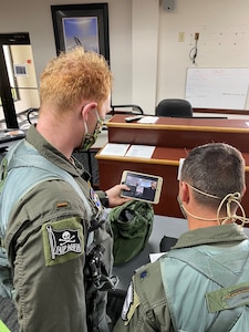 Second Lt. Frank Toohey and 559th Flying Training Squadron instructor pilot Lt. Col. Dan Healey recieve a brief from operations superintendent Lt. Col. John Urso and Jeff Madison of the 12th Operations Support Squadron.