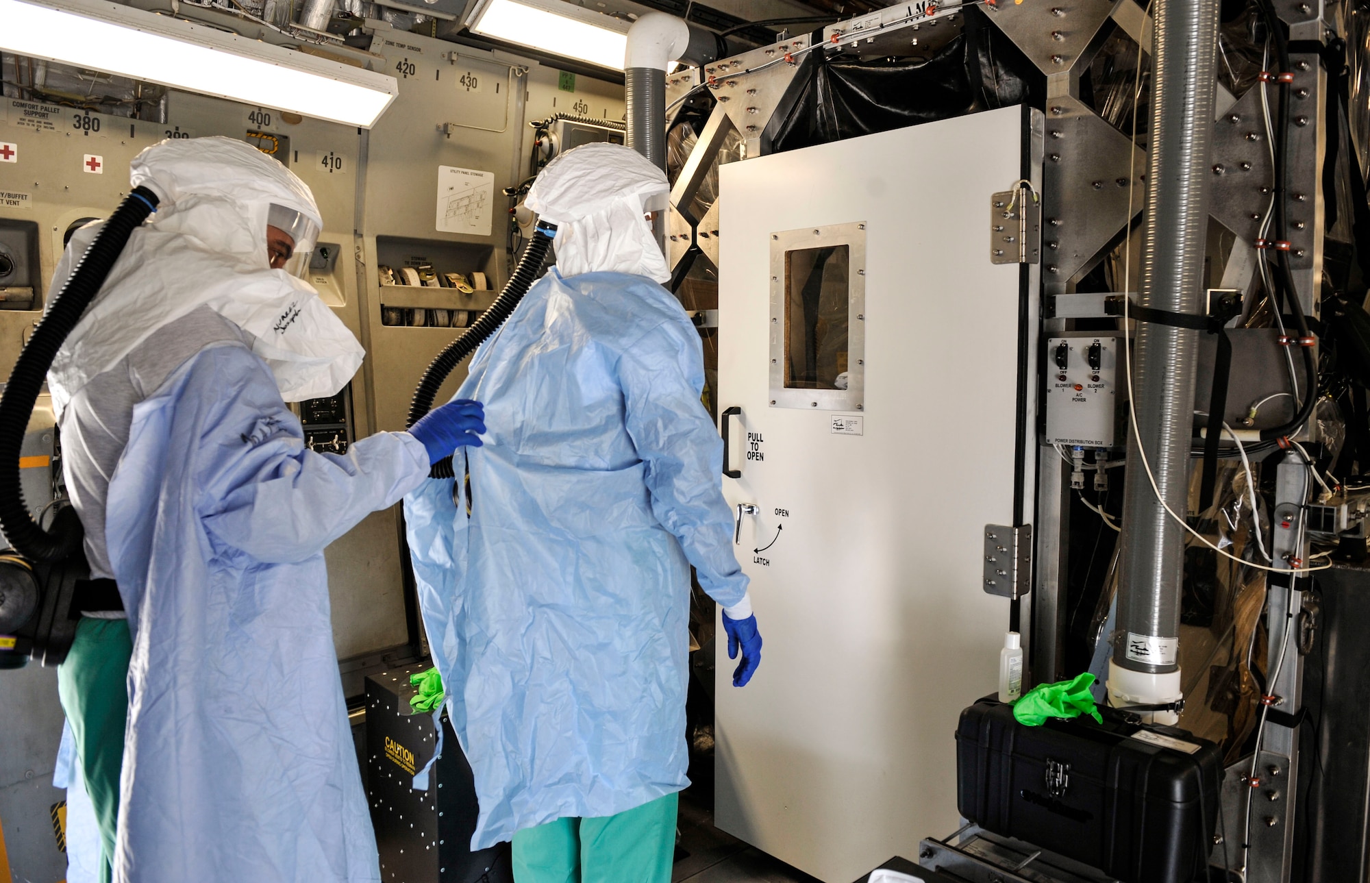 Airmen participating in Transport Isolation System training perform an equipment check during a training scenario at Joint Base Charleston, S.C., April 5, 2020.