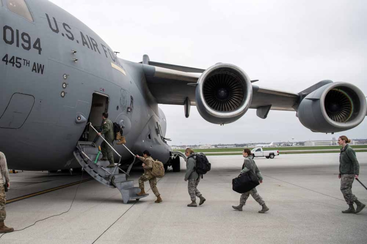 Doctors and nurses board plane.