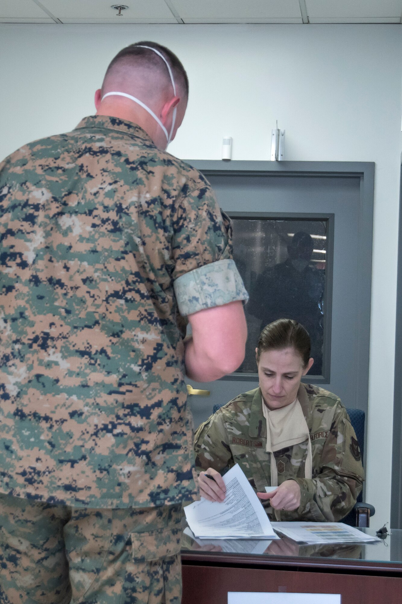 Chief Master Sgt. Vicki Robertson, 94th Airlift Wing command chief, registers a Marine as he arrives to meet with the Dobbins legal team on April 9, 2020. This week, the Dobbins legal office helped more than 60 Marines with legal documents in preparation for a short-notice deployment to assist in the battle against COVID-19. Due to the short notice, the command chief stepped in to help the legal team. (U.S. Air Force photo/Andrew Park)