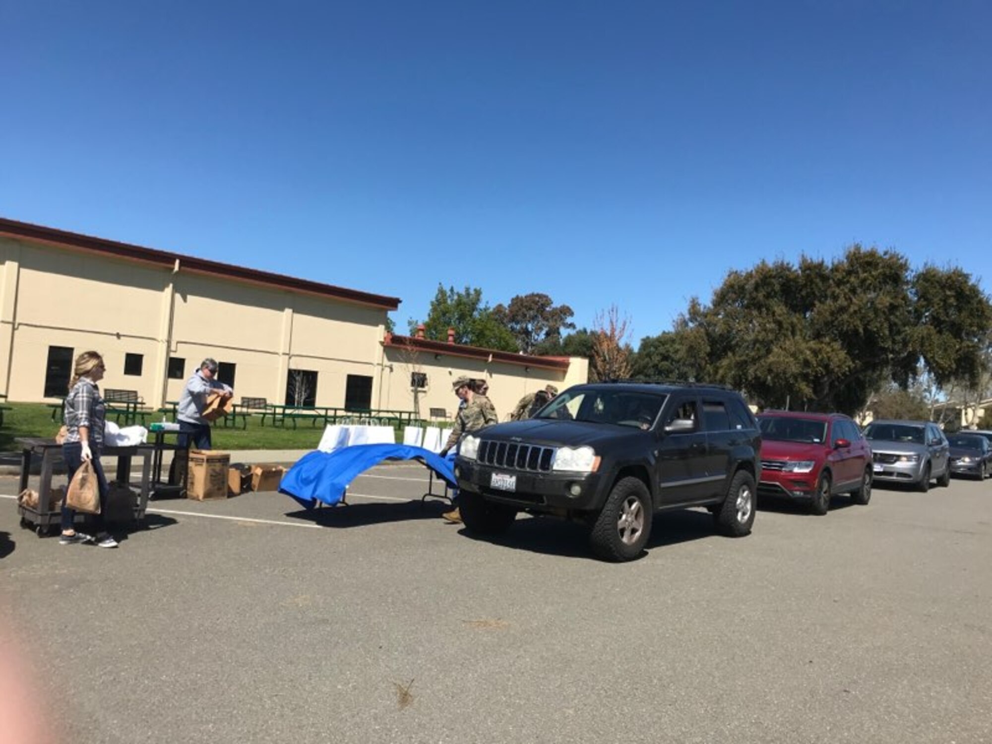 Cars lined up to receive relief kits.