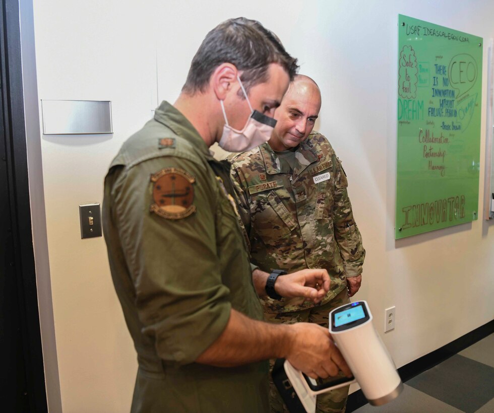 Maj. Vincent Giacomino, 11th Wing SparkX Cell chief innovation officer, shows Col. Andrew Purath, 11th Wing and Joint Base Andrews commander, their 3D modeling software at the SparkX Cell Innovation and Idea Center on JBA, Md., Apr. 8, 2020. Purath’s face was 3D modeled to show custom fit facemask printing capabilities. (U.S. Air Force photo by Airman 1st Class Spencer Slocum)