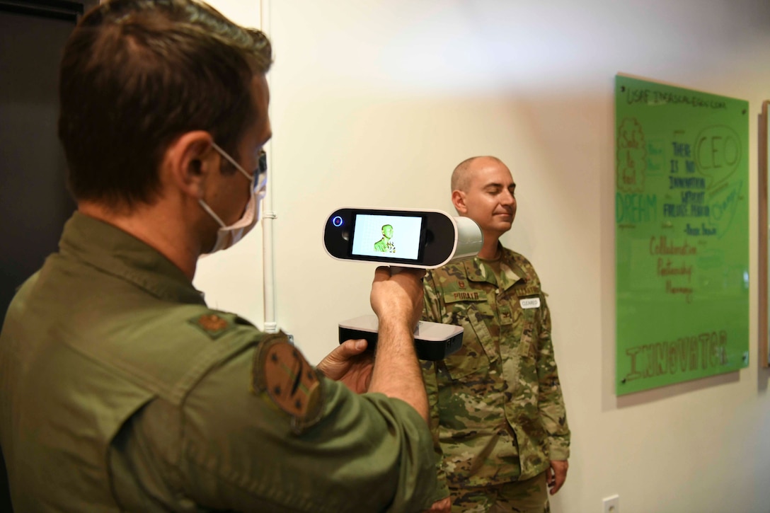 Maj. Vincent Giacomino, 11th Wing SparkX Cell chief innovation officer, scans the face of Col. Andrew Purath, 11th Wing and Joint Base Andrews commander, for a 3D model at the SparkX Cell Innovation and Idea Center on JBA, Md., Apr. 8, 2020. Purath’s face was 3D modeled for a custom fit mask, which was printed the next day to show 3D facemask printing capability. All individuals on Department of Defense property, installations and facilities must wear face coverings when they cannot maintain six feet of social distancing. (U.S. Air Force photo by Airman 1st Class Spencer Slocum)