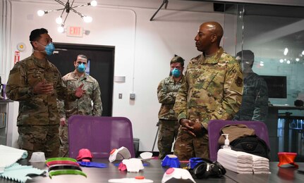 Staff Sgt. Andy Keala Anoa’i Renteria (left), 11th Wing SparkX Cell innovations technician, briefs Chief Master Sgt. Kaleth O. Wright, Chief Master Sgt. of the Air Force, on their 3D modeling software at the SparkX Cell Innovation and Idea Center on JBA, Md., Apr. 10, 2020. Wright’s face was 3D modeled to show custom fit facemask printing capabilities. (U.S. Air Force photo by Airman 1st Class Spencer Slocum)