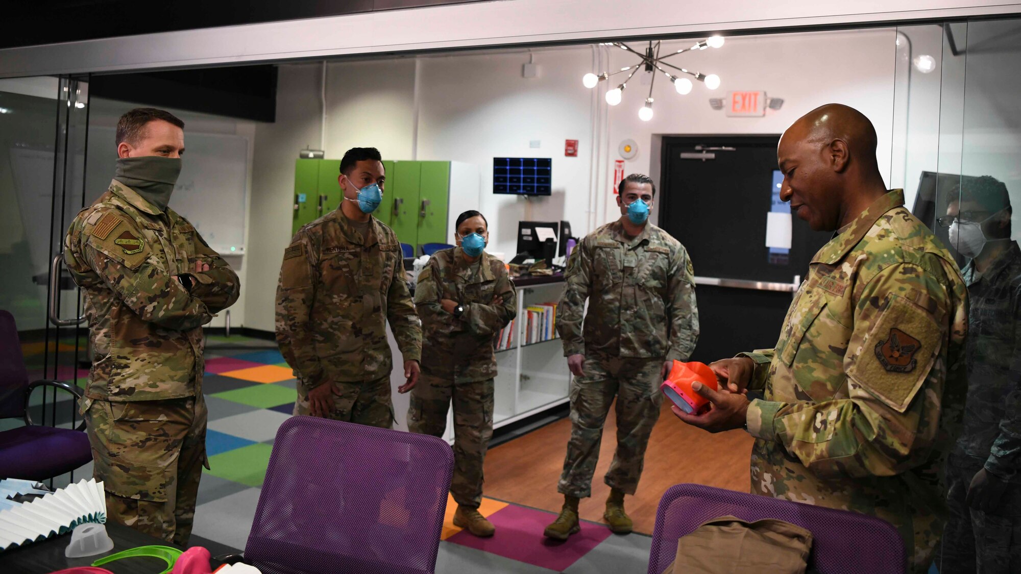 Chief Master Sgt. Kaleth O. Wright, Chief Master Sgt. of the Air Force (right), views a prototyped facemask at the SparkX Cell on JBA, Md., Apr. 10, 2020. Each single model of facemask printed takes varying amounts of time to print, with the quickest being three hours and the longest up to eight hours. SparkX Cell team members have been making prototype personal protective equipment in an effort to help prevent the spread of COVID-19.  (U.S. Air Force photo by Airman 1st Class Spencer Slocum)
