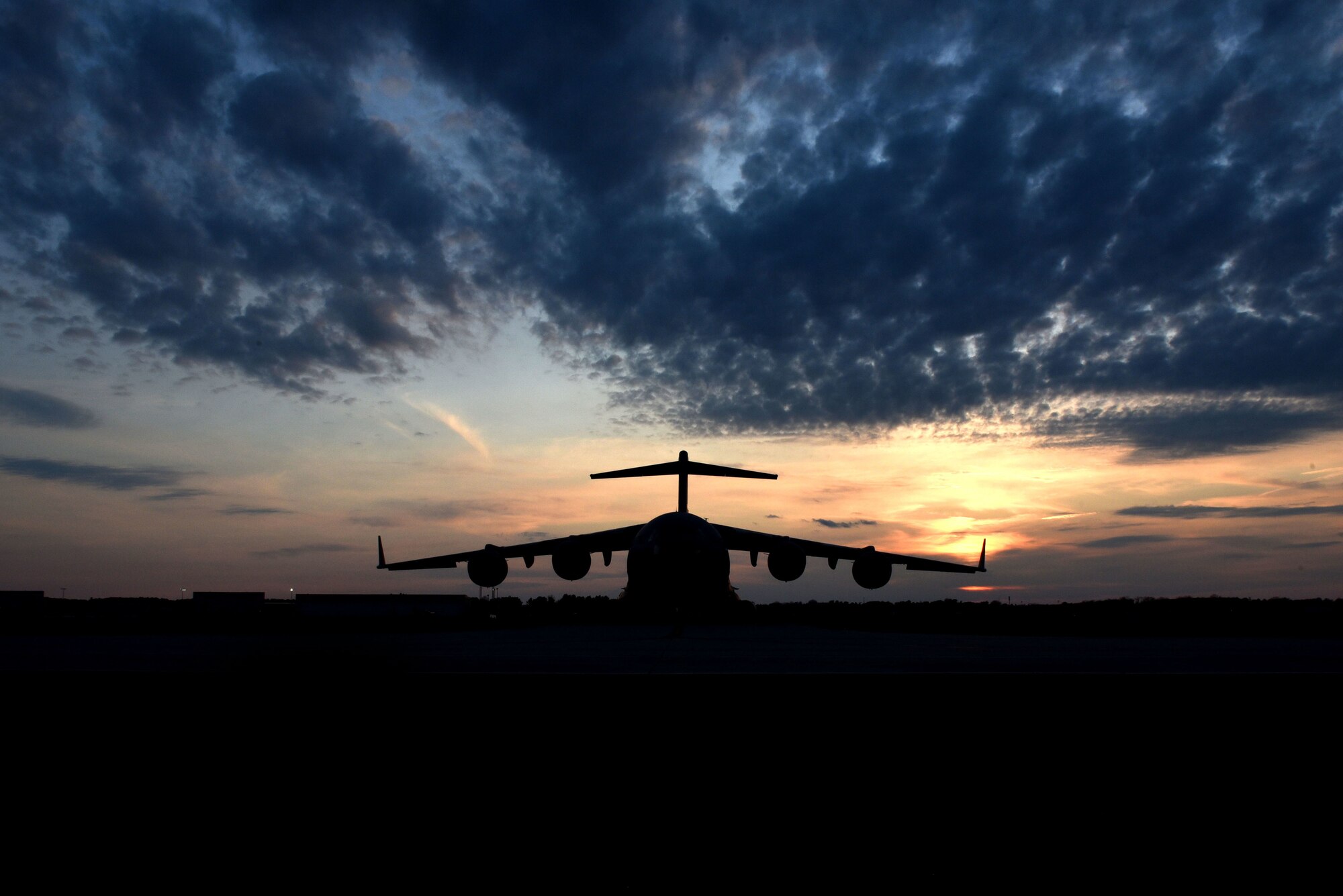 A C-17 Globemaster III sits on the flightline