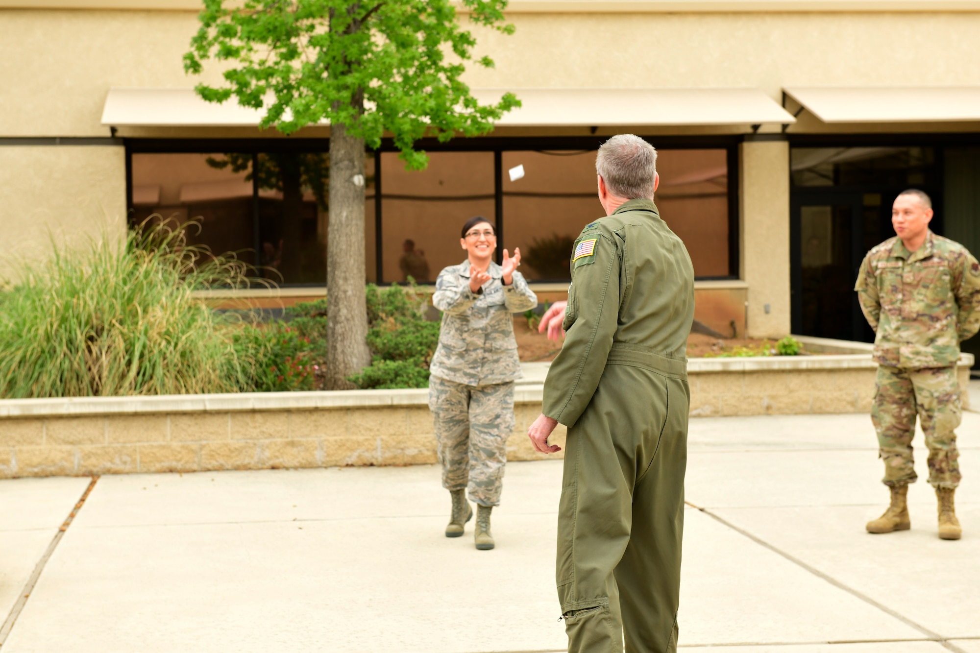 Senior Master Sgt. catches a commander's coin during a ceremony