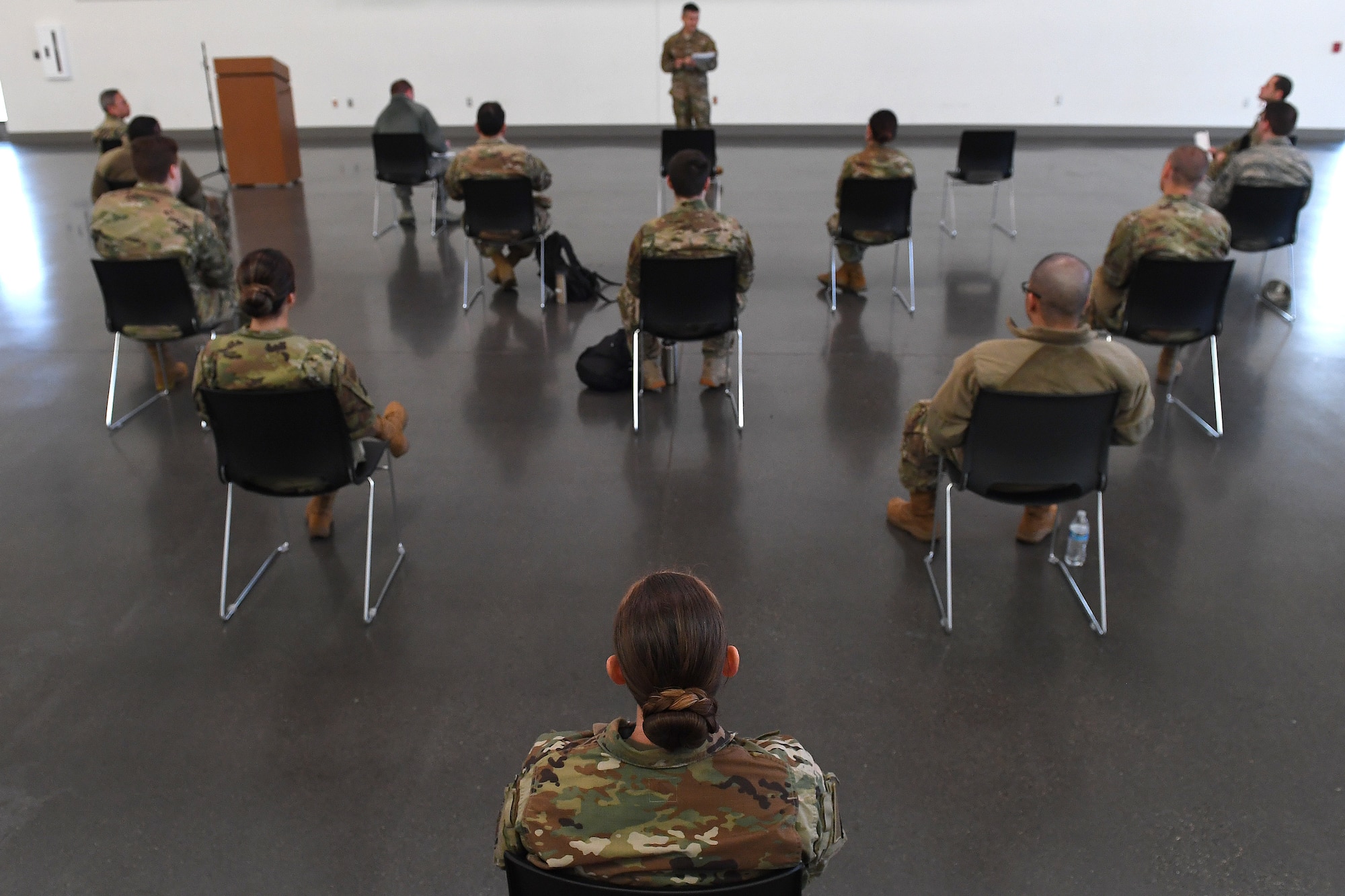 Airmen receive instructions from COVID-19 response team