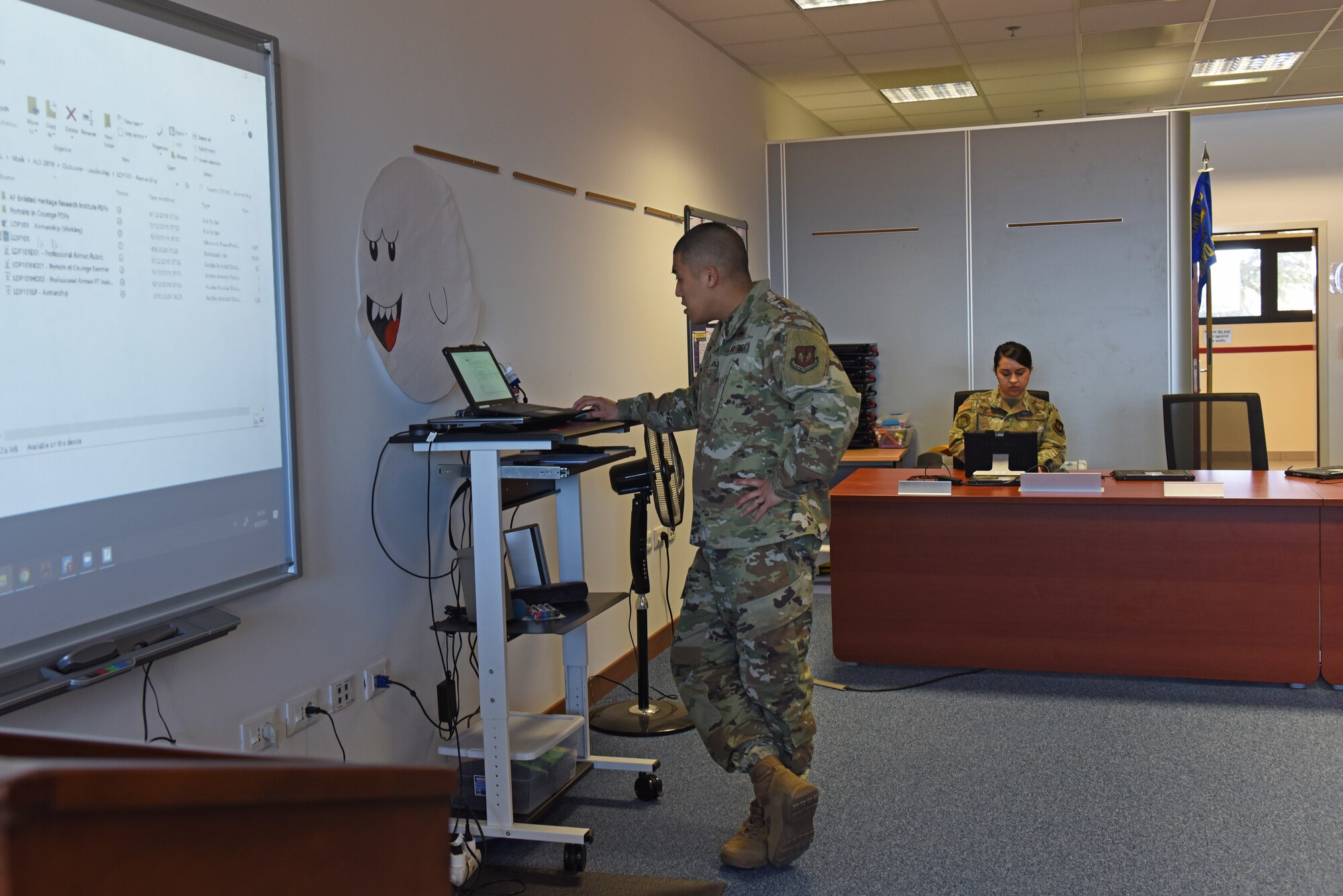 Air Force Staff Sgt. Justin Bow and Air Force Staff Sgt. Krystal Lindsey, instructors at the Tech. Sgt. Adam K. Ginett Airman Leadership School, run through practice lessons in preparation for a virtual ALS course at Aviano Air Base, Italy, April 9, 2020. A few lessons were modified but students will still be able to meet lesson intent as directed by the Barnes Center Instruction and will still be able to participate in guided discussions. (U.S. Air Force photo by Staff Sgt. Valerie Halbert)