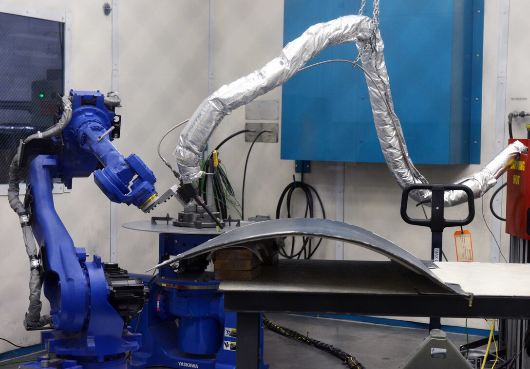 The cold spray machine repairs a B-1B Lancer panel.