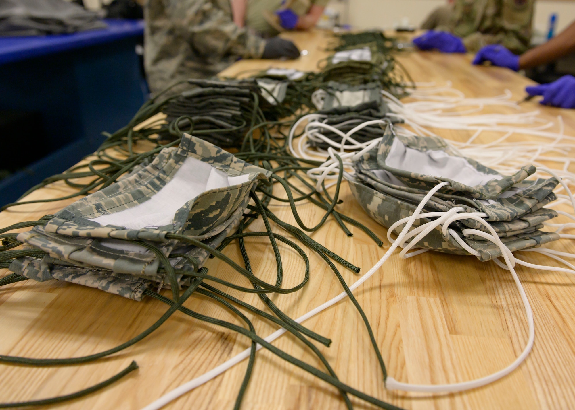 Masks made by the 366th Operations Support Squadron lay on a work table after production, March 20, 2020, at Mountain Home Air Force Base. These mask are made for people on base and help to prevent the spread of COVID-19. (U.S. Air Force photo by Senior Airman Tyrell Hall)