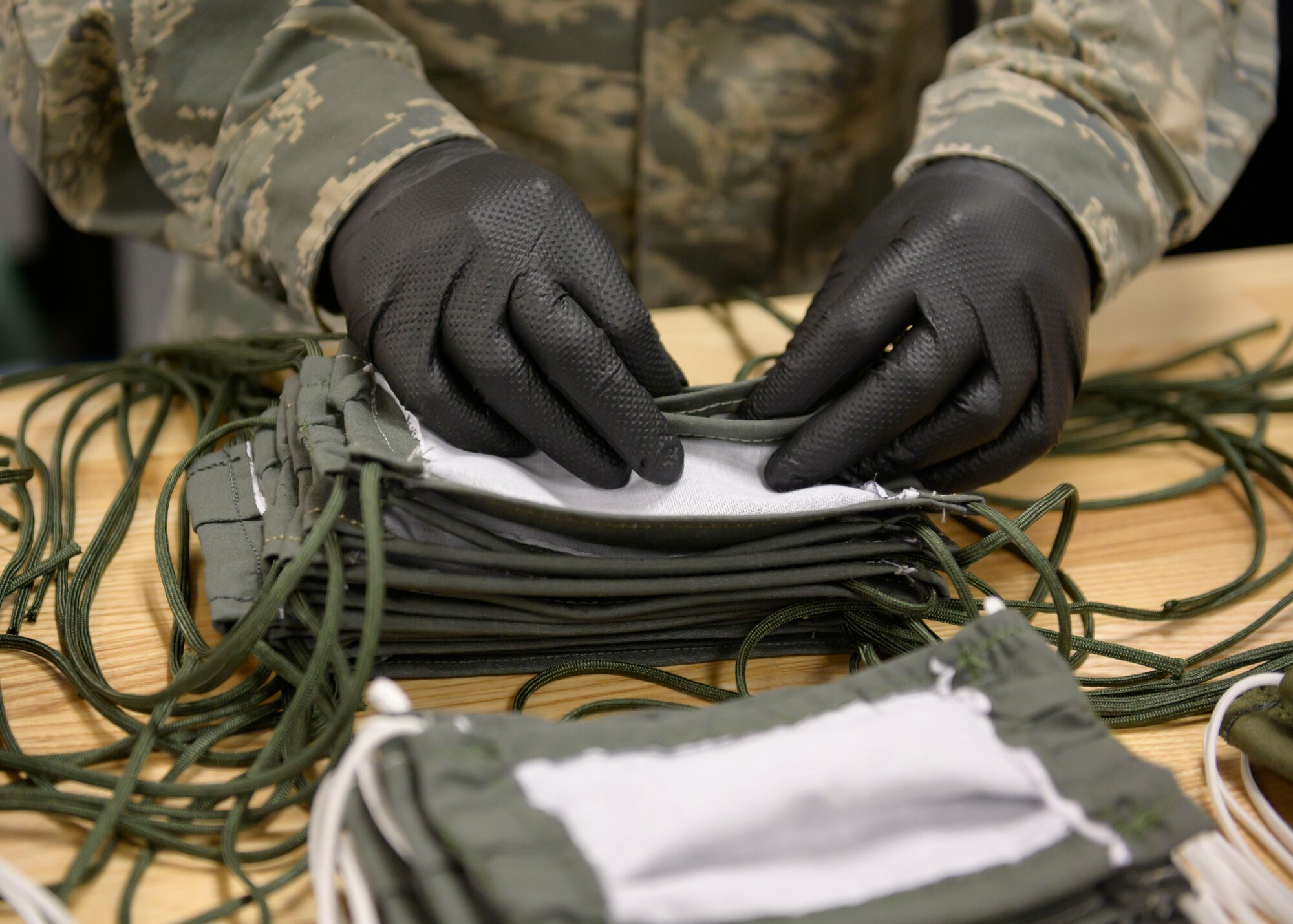 Airmen from the 366th Operations Support Squadron, craft masks for personnel on base, March 20, 2020, at Mountain Home Air Force Base, Idaho. These masks are designed in a multi-layer style to further deter the spread of CVOID-19. (U.S. Air Force photo by Senior Airman Tyrell Hall)